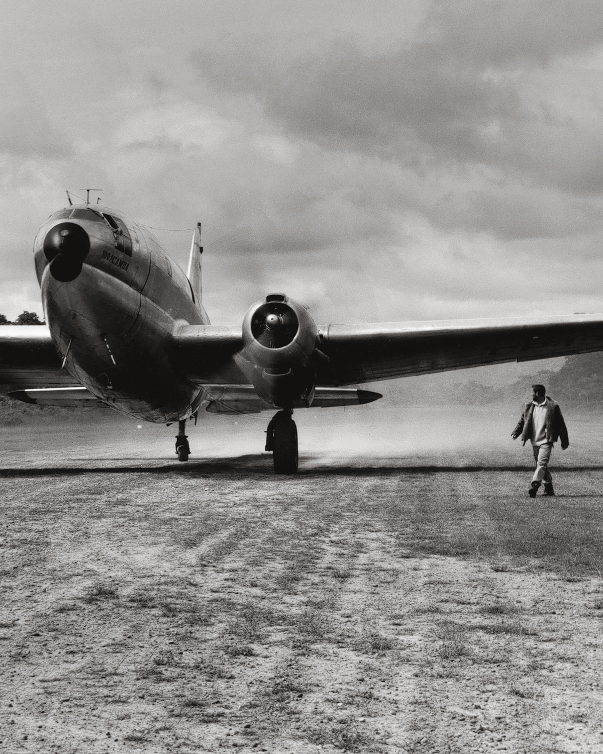 PME Legend campaign in black and white: a classic cargo aircraft and a man walking beside it